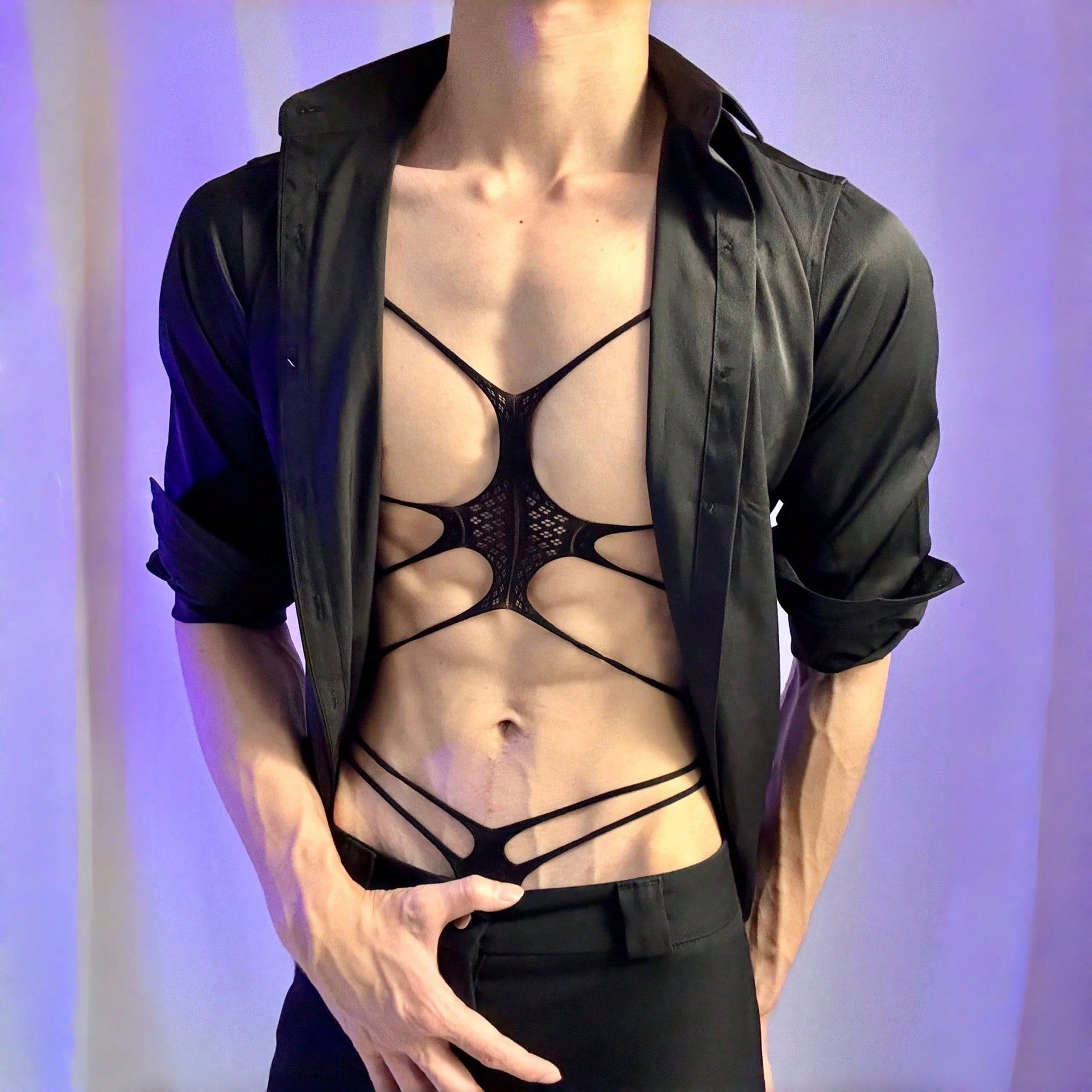 Men's black semi-sheer cut-out bodysuit lingerie with hollow-out design, low-rise fit, short length, and fake print pattern.