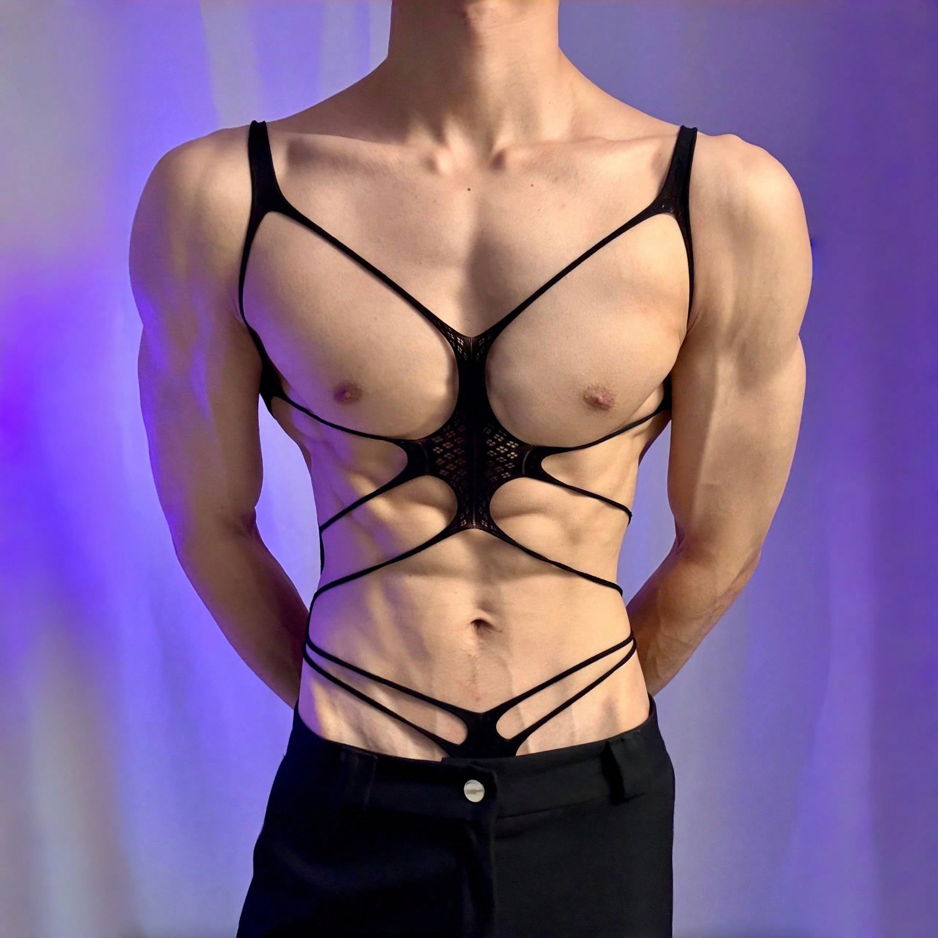 Men's black semi-sheer cut-out bodysuit lingerie with hollow-out design, low-rise fit, short length, and fake print pattern.