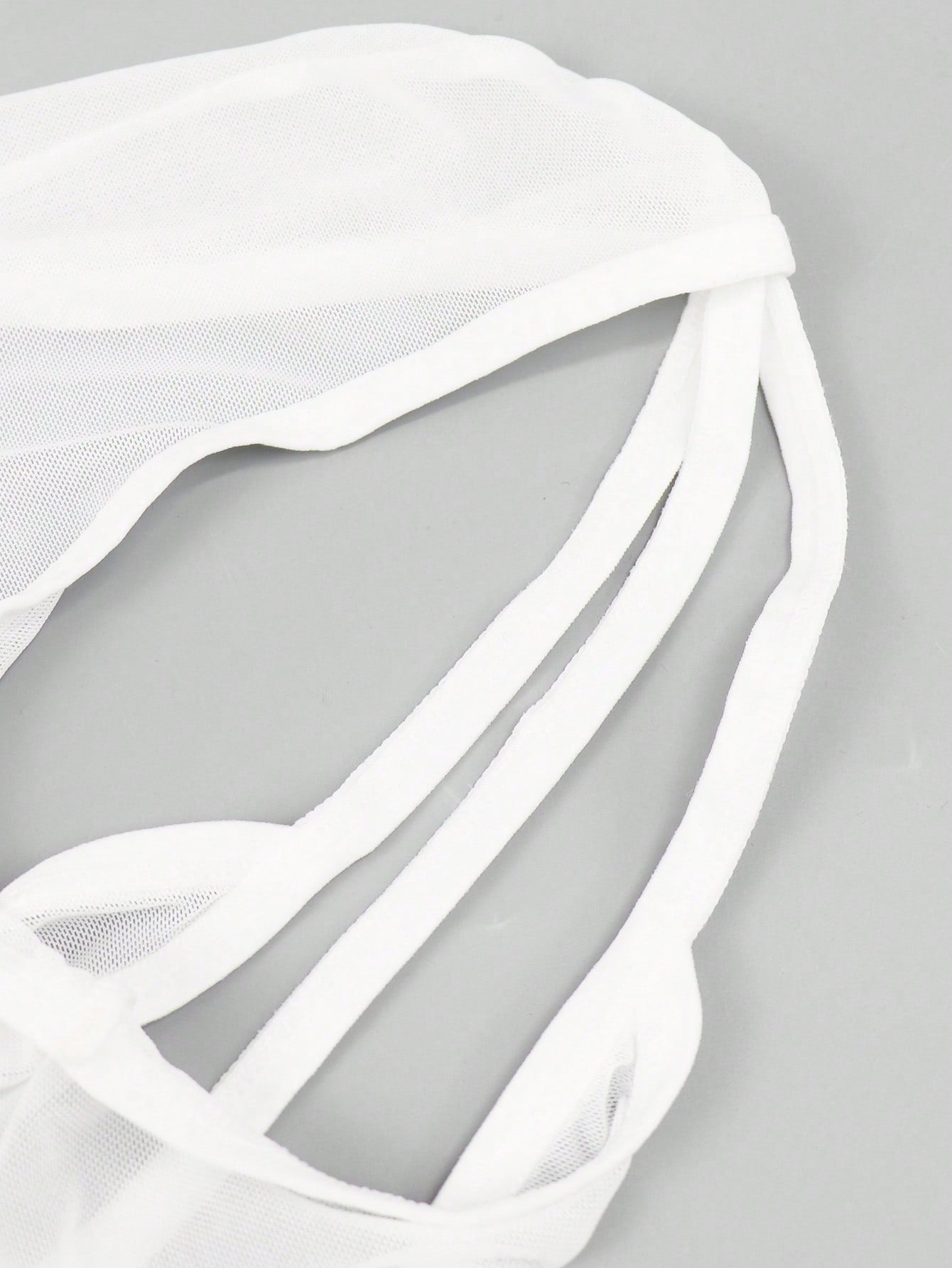 Men's white mesh thong underwear with deep V-neck, cut-out detail, plain design, and mid-rise fit.