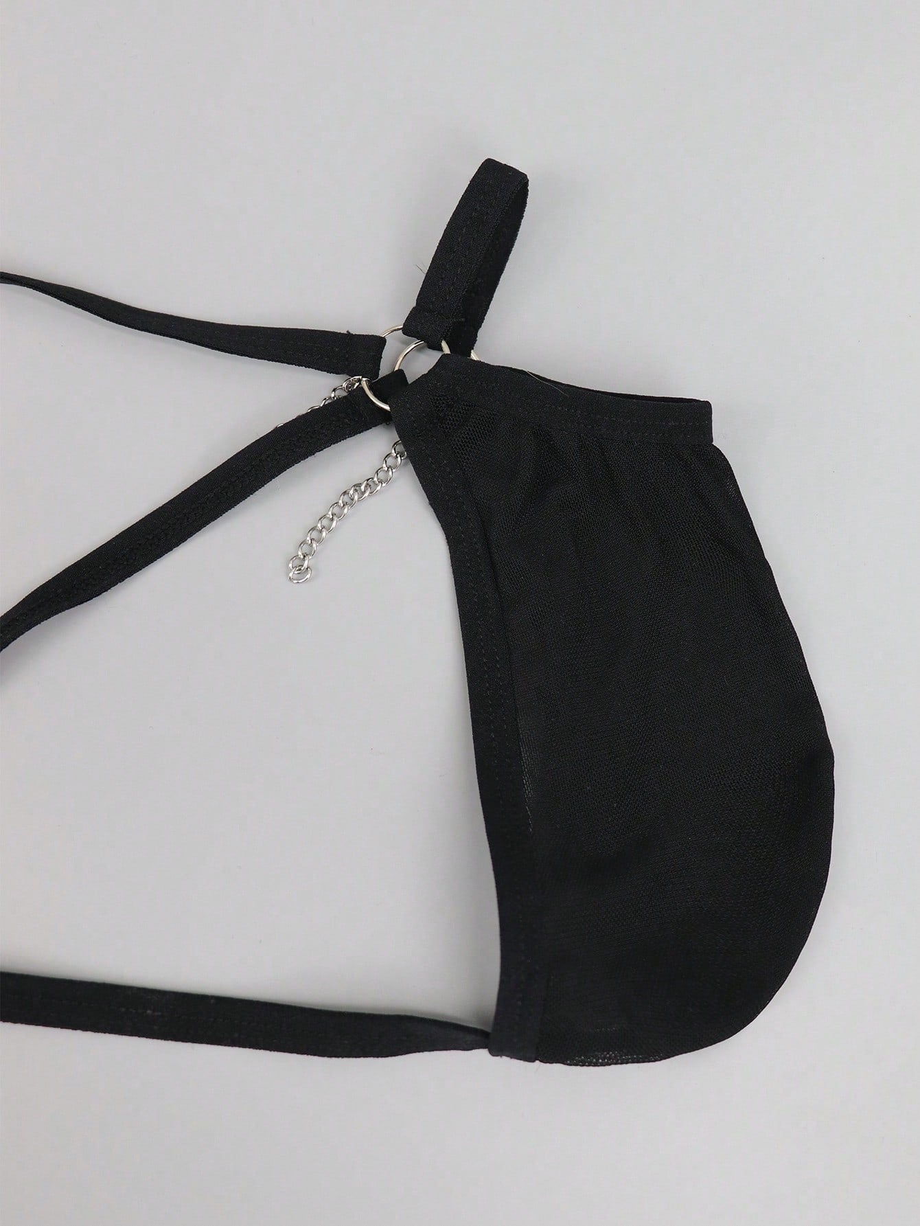 Men's black mesh low-rise thong with colorblock design and chain accessory detail