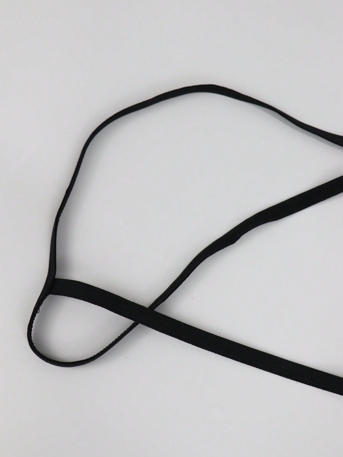 Men's black mesh low-rise thong with colorblock design and chain accessory detail