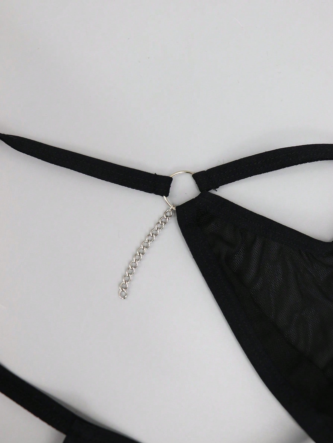 Men's black mesh low-rise thong with colorblock design and chain accessory detail