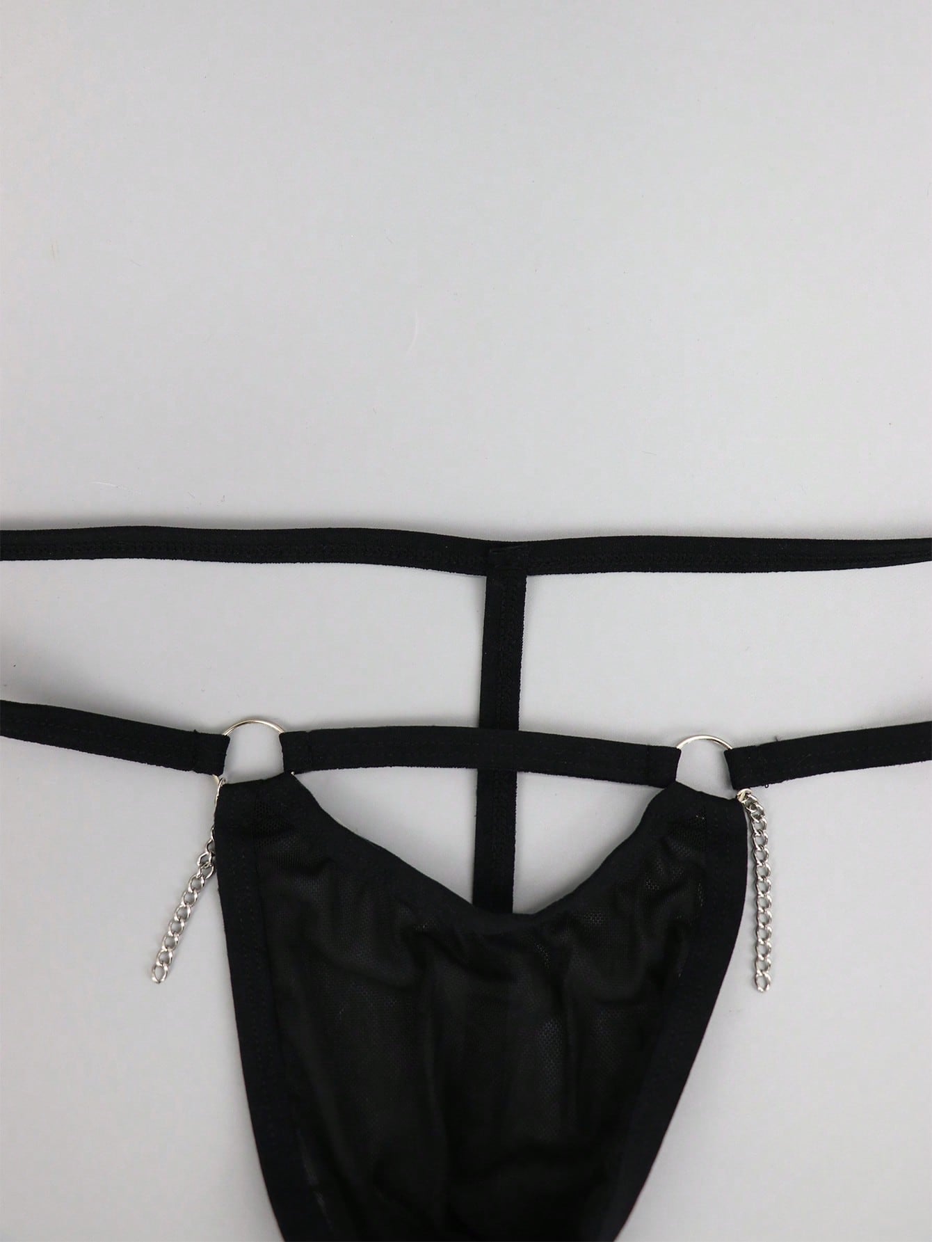 Men's black mesh low-rise thong with colorblock design and chain accessory detail
