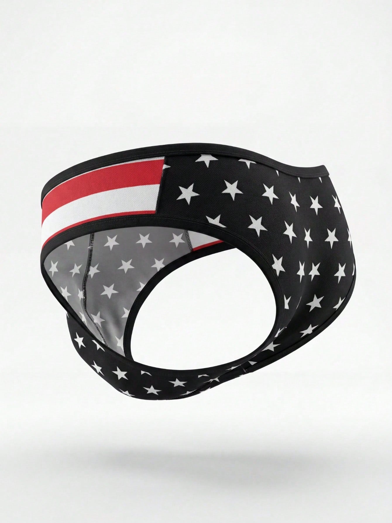 Men's black low-rise thong underwear with geometric striped star print, high-stretch knitted fabric, non-sheer design