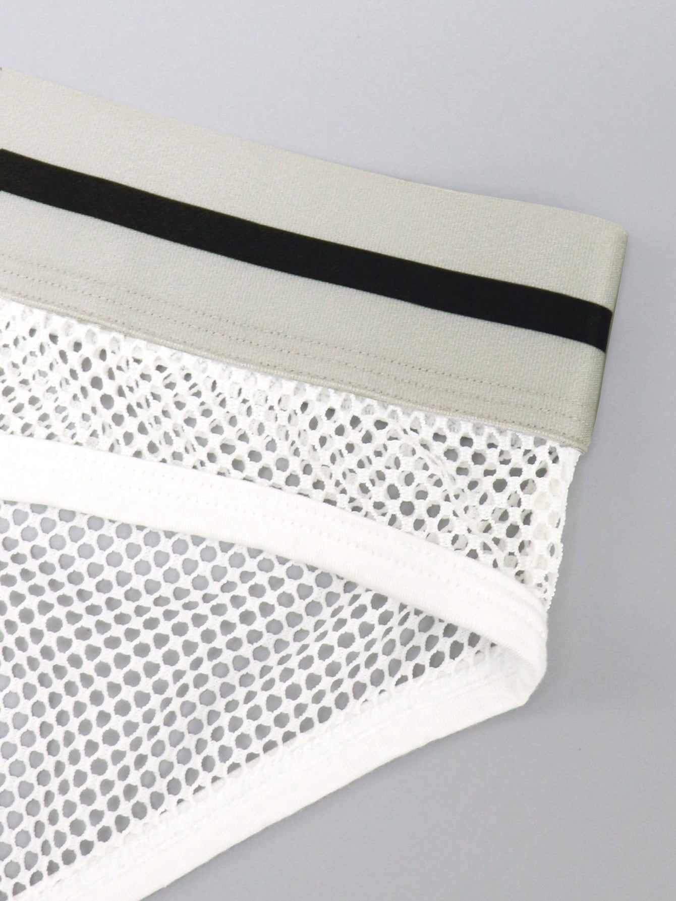 Men's contrast letter print mesh briefs with low-rise cut, tape detail, and contrast binding
