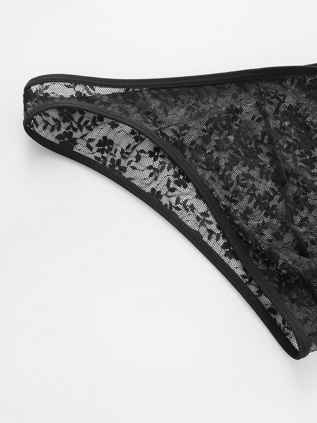 Men's black semi-sheer lace low-rise thong briefs with colorblock styling