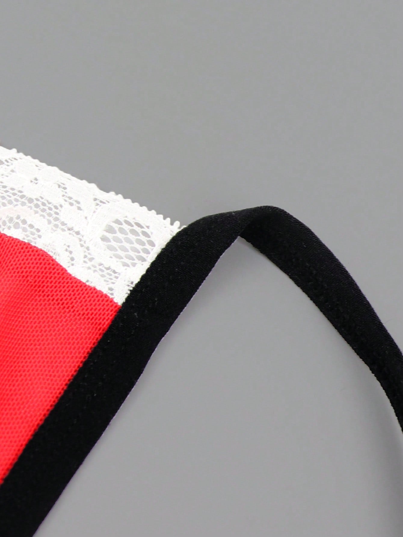 Men's low-rise mesh thong underwear with contrast lace waist, contrast binding, and colorblock design