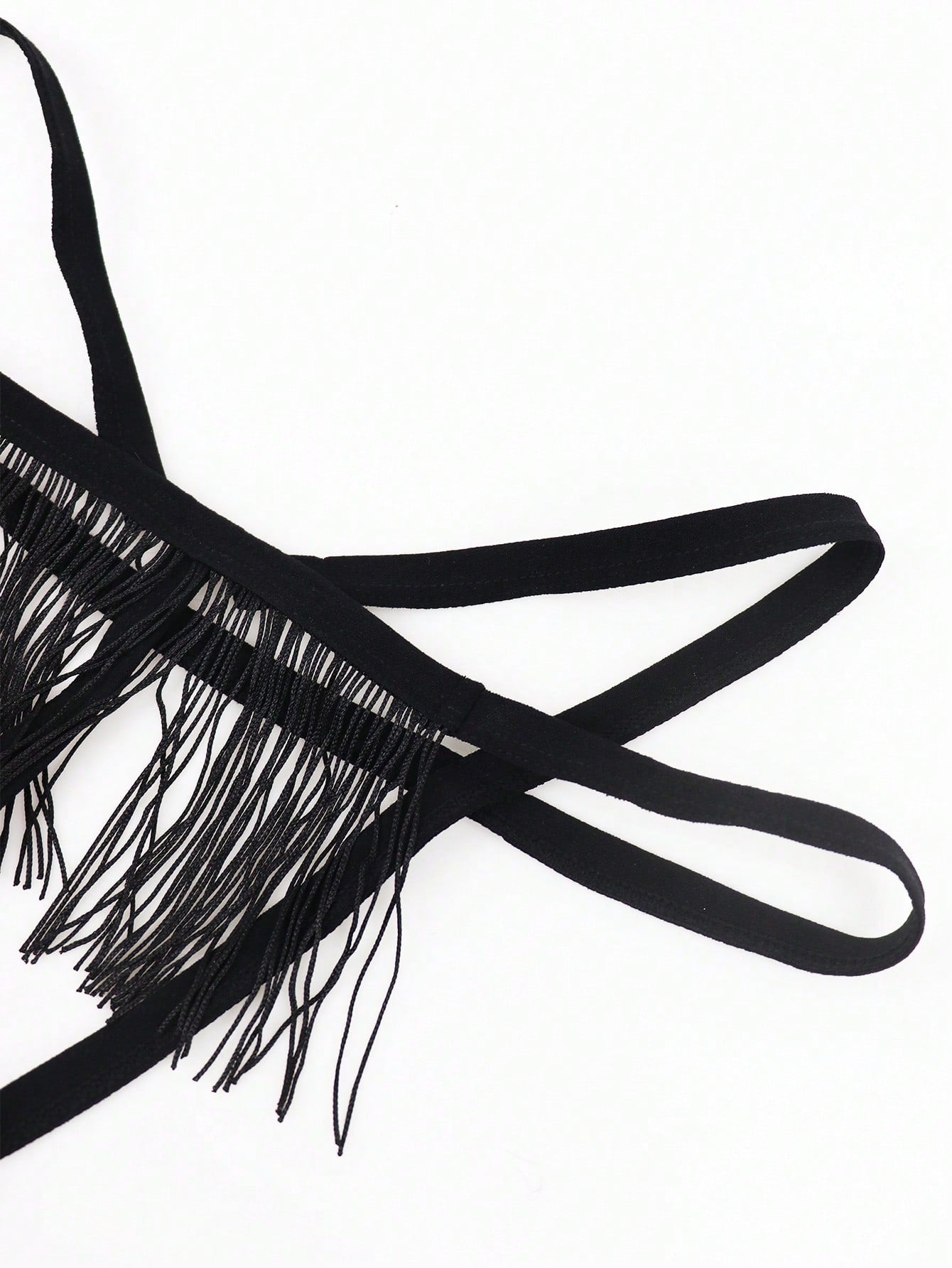 Men's black low-rise thong underwear with fringe detail, plain knitted fabric, and a non-sheer finish