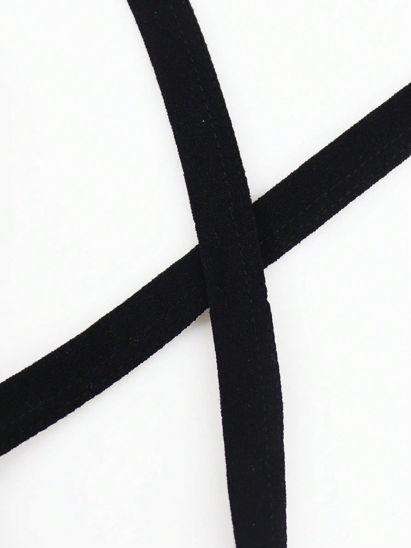 Men's black low-rise thong underwear with fringe detail, plain knitted fabric, and a non-sheer finish