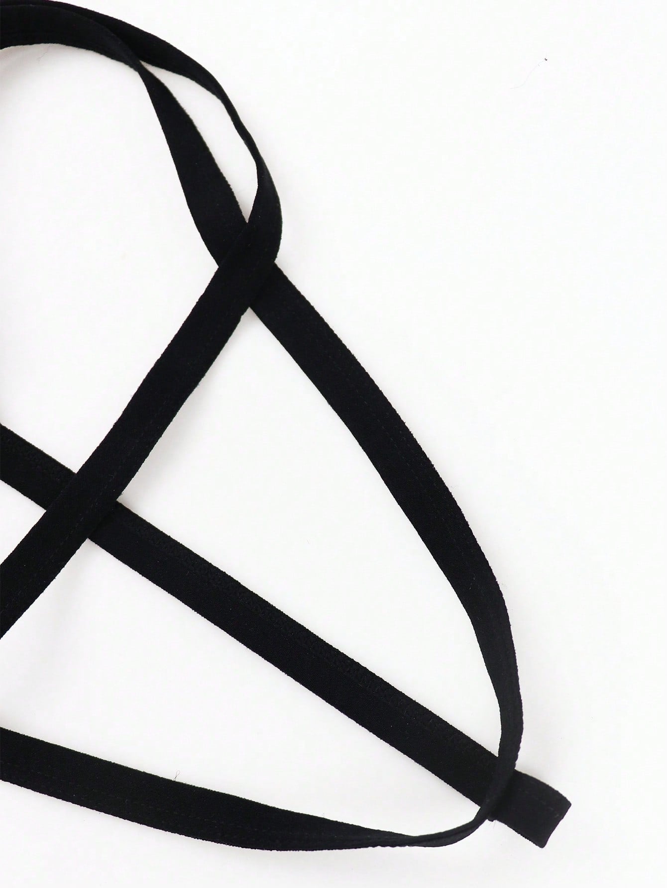 Men's black low-rise thong underwear with fringe detail, plain knitted fabric, and a non-sheer finish