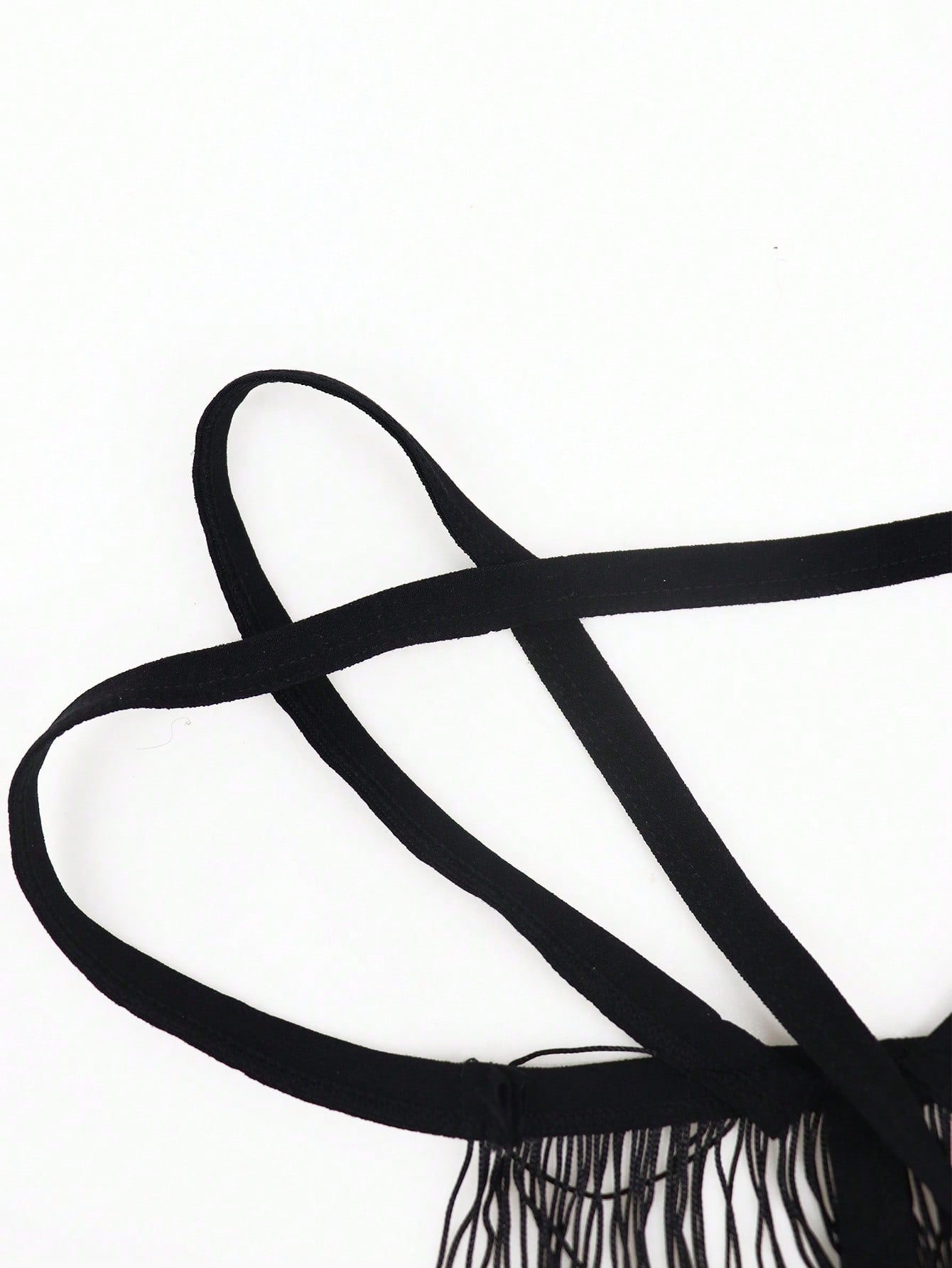 Men's black low-rise thong underwear with fringe detail, plain knitted fabric, and a non-sheer finish