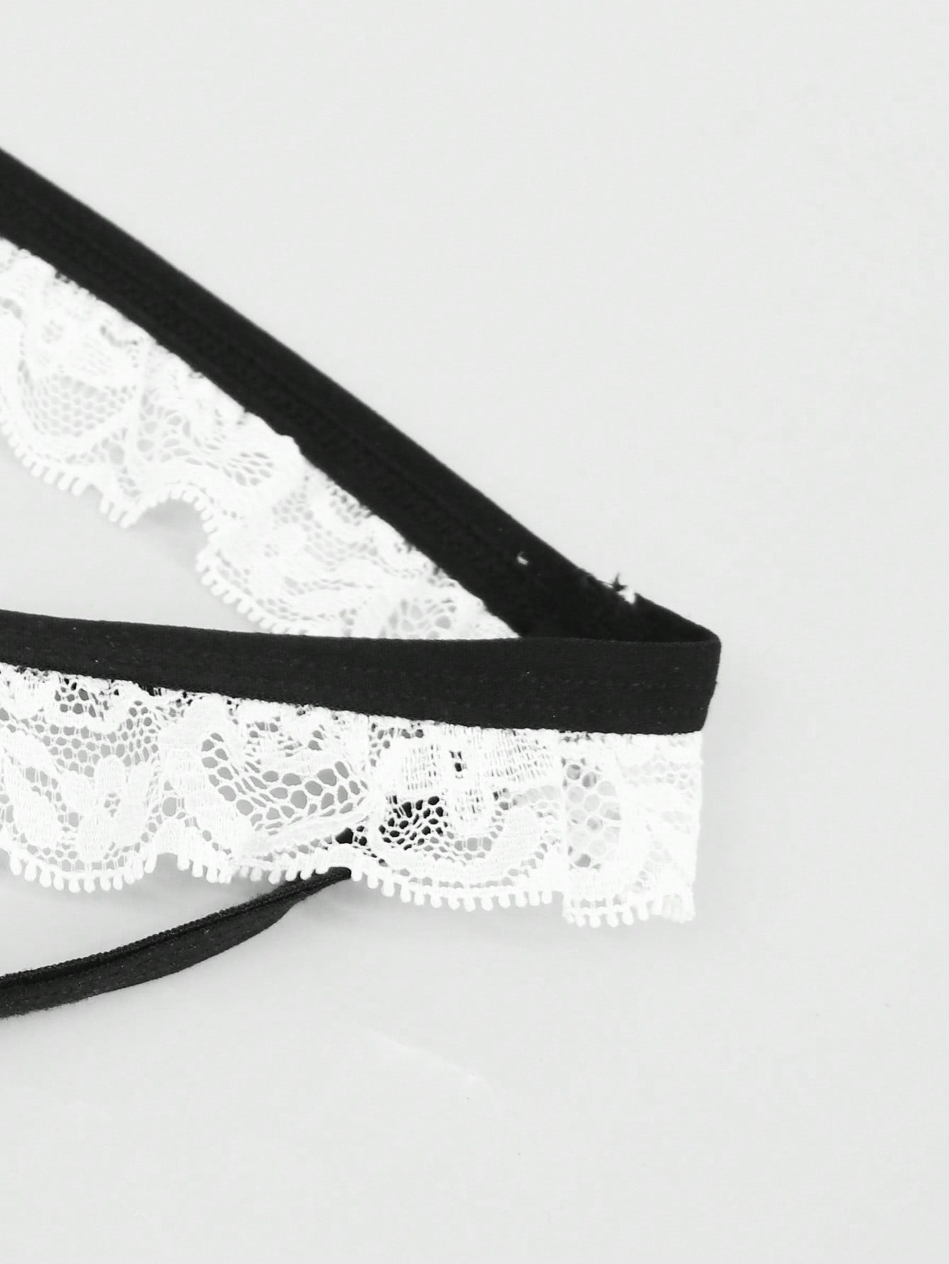 Men's black and white colorblock mid-rise thong made from mesh fabric with lace detailing