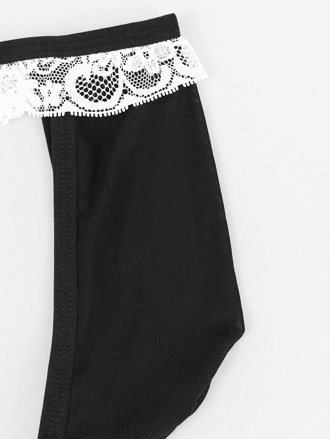 Men's black and white colorblock mid-rise thong made from mesh fabric with lace detailing