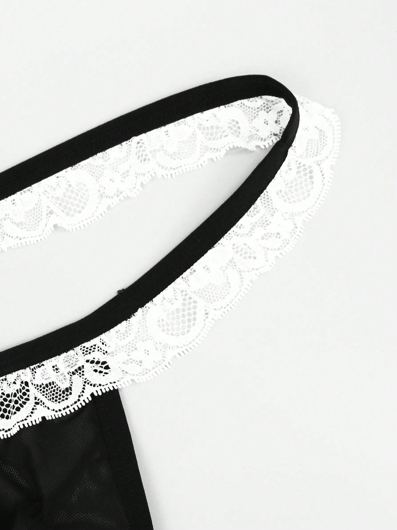 Men's black and white colorblock mid-rise thong made from mesh fabric with lace detailing