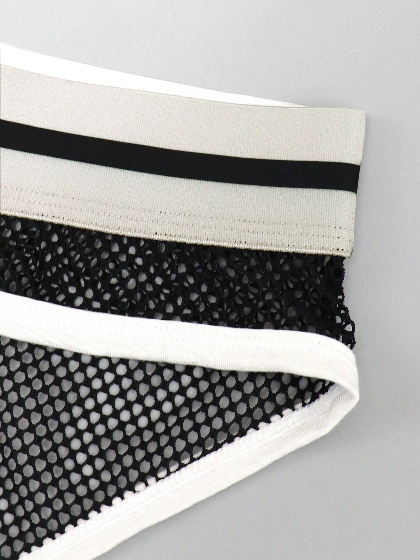 Men's contrast letter print mesh briefs with low-rise cut, tape detail, and contrast binding