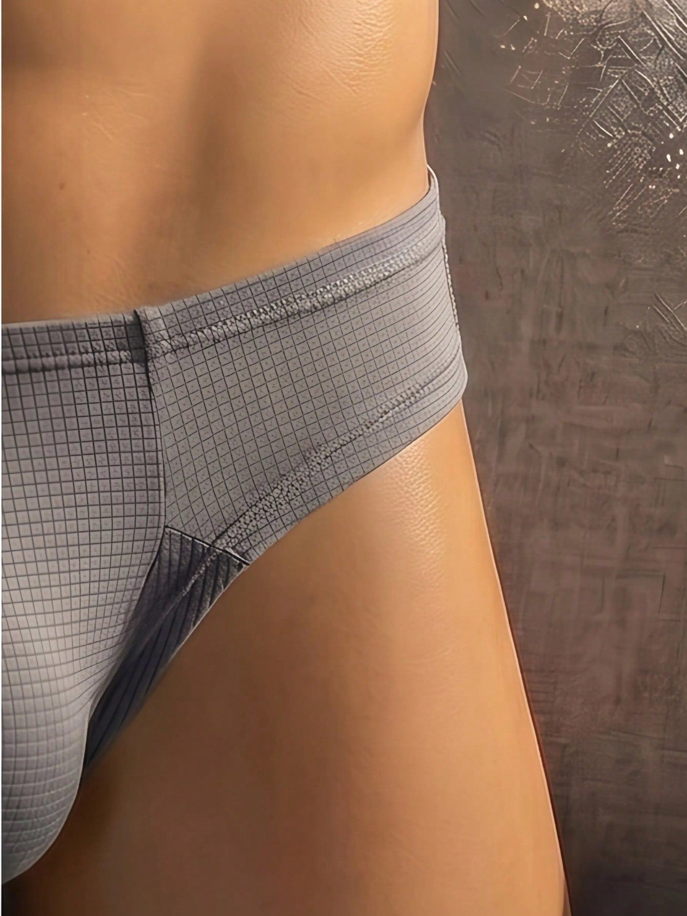 Men's low rise T-back thong briefs in a plain design with revealing back coverage