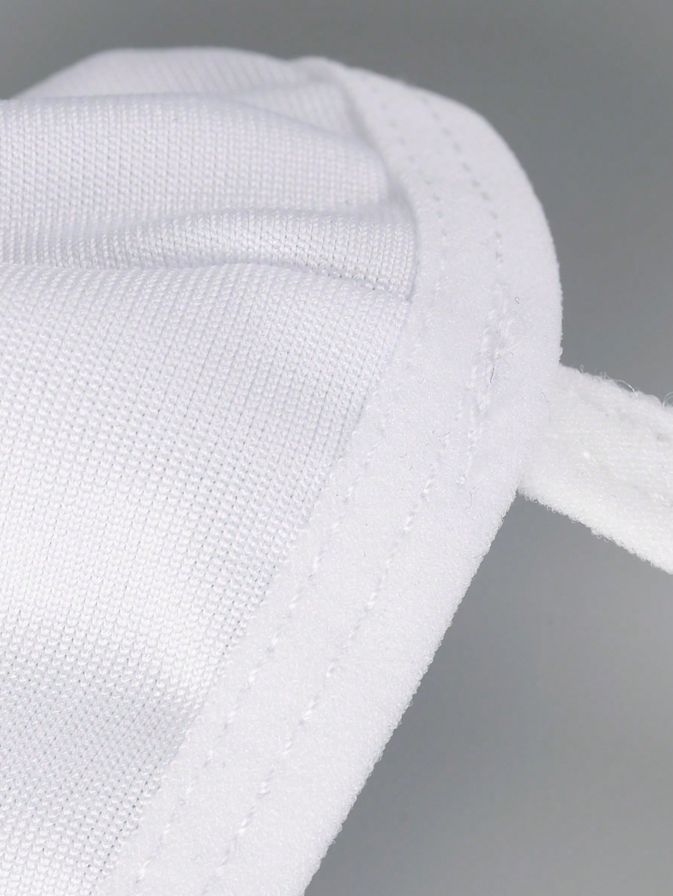 Men's white low-rise thong underwear with contrast lace detail and mesh fabric