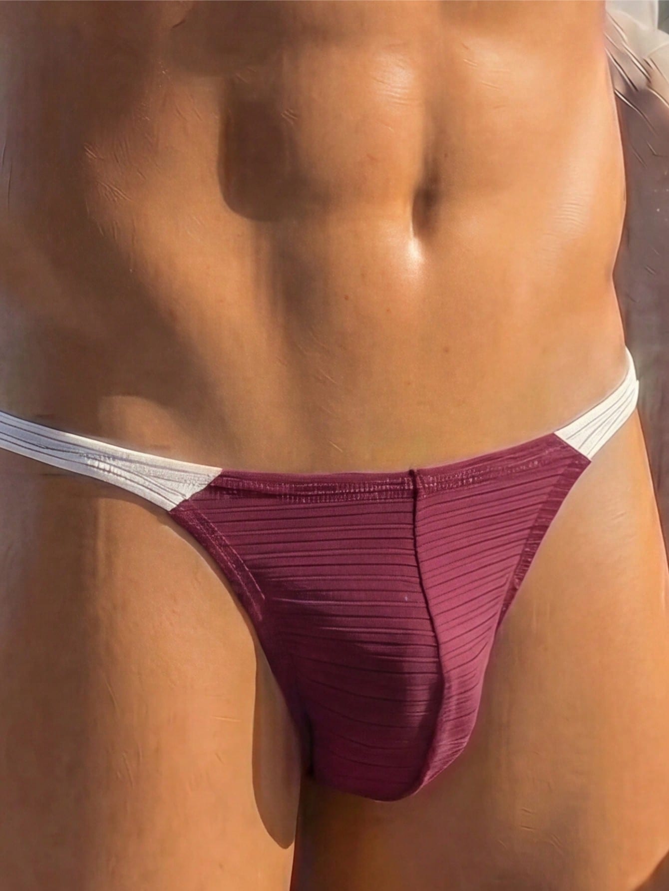 Plain men's mid-rise thong underwear with an elastic waistband and minimal back coverage.