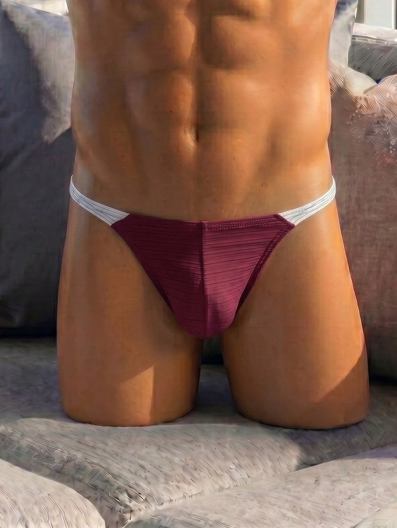 Plain men's mid-rise thong underwear with an elastic waistband and minimal back coverage.