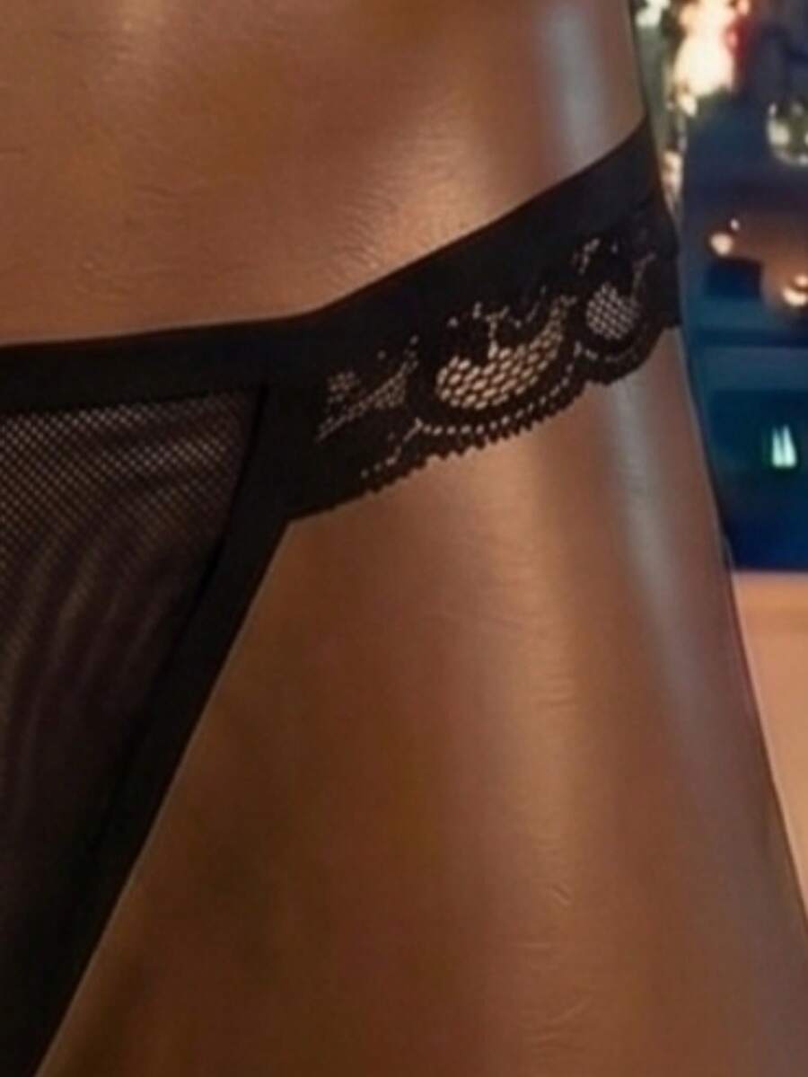 Black men's hollow mesh backless jockstrap featuring a lace waistband, low-rise fit, and double pouch design.