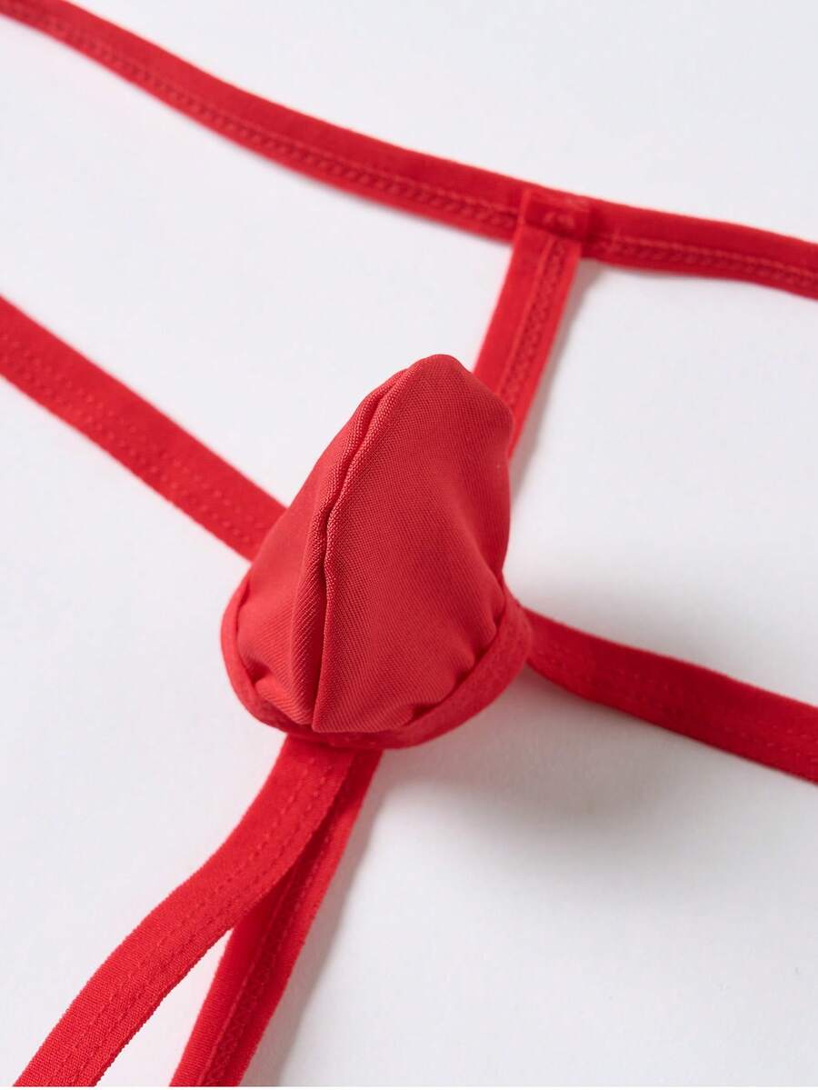 Men's red colorblock low-rise thong underwear made from medium-stretch knitted fabric.