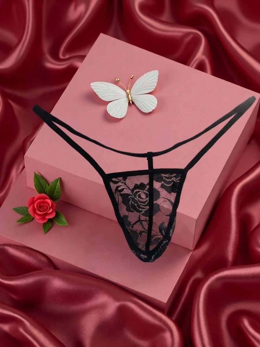 Black men's low waist thong featuring semi-sheer hollow out floral lace fabric.