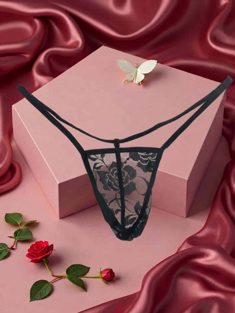 Black men's low waist thong featuring semi-sheer hollow out floral lace fabric.