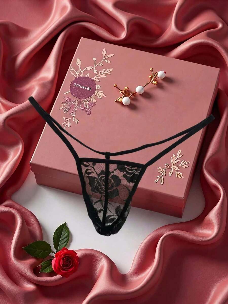 Black men's low waist thong featuring semi-sheer hollow out floral lace fabric.