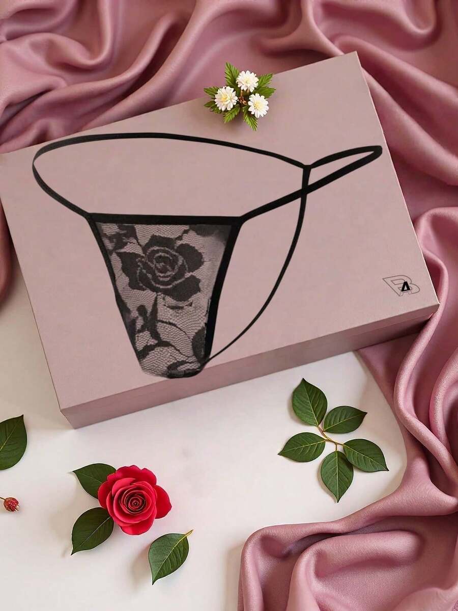 Black men's low waist thong featuring semi-sheer hollow out floral lace fabric.