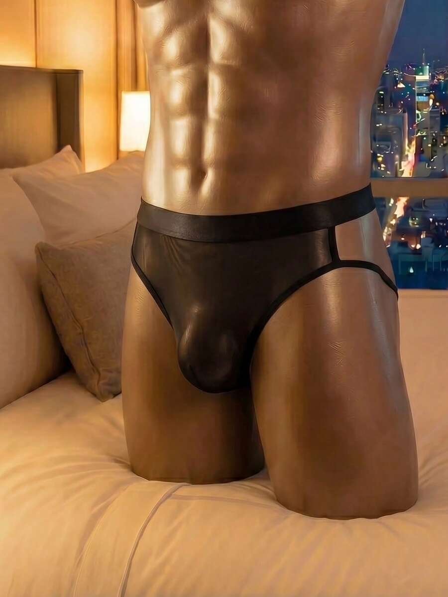Men's black low rise briefs featuring contrast mesh and cut out details.