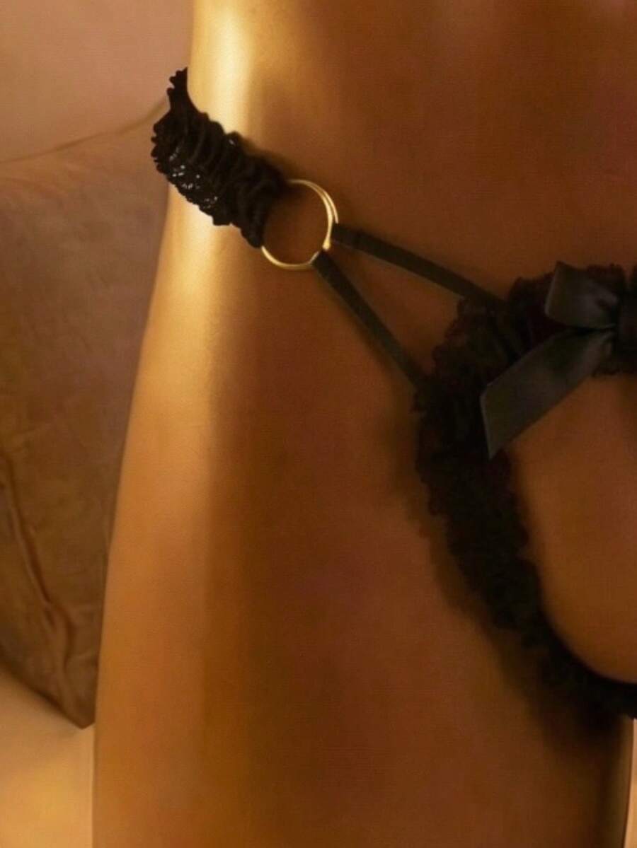 Men's black lace low-rise V-string thong with hollow bow detail